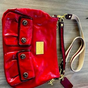Coach shoulder bag in red patent leather. Dark interior, dust bag included.